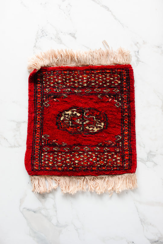 vintage Persian placemat sized rug, red