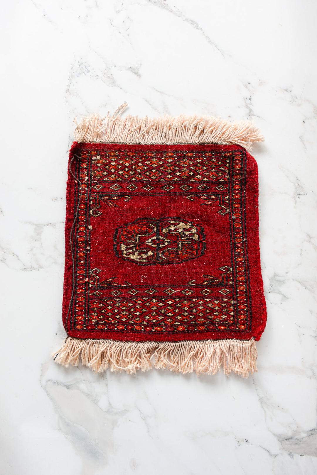 vintage Persian placemat sized rug, red