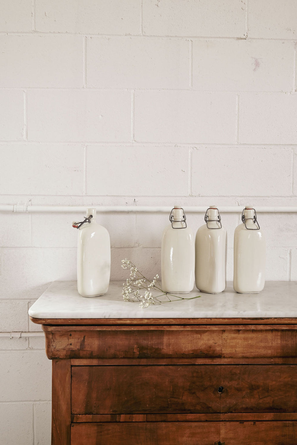 vintage french triangular stonware bottle with procelain lid