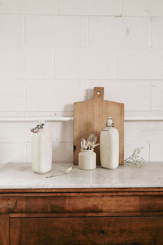 vintage french triangular stonware bottle with procelain lid