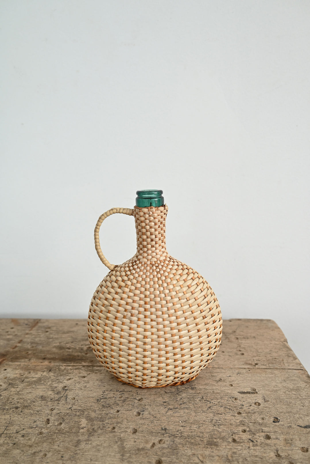 vintage woven handled demijohn