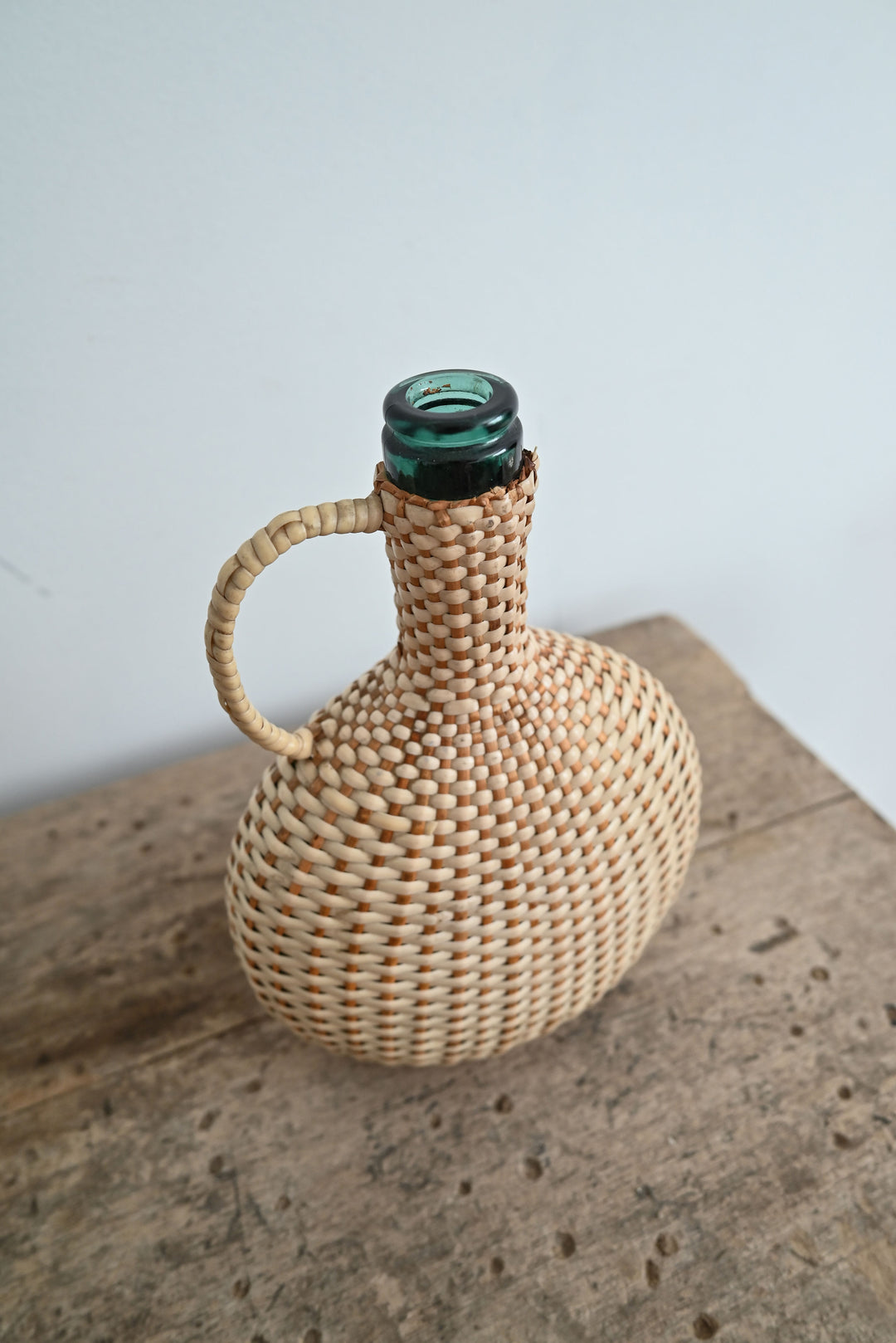 vintage woven handled demijohn