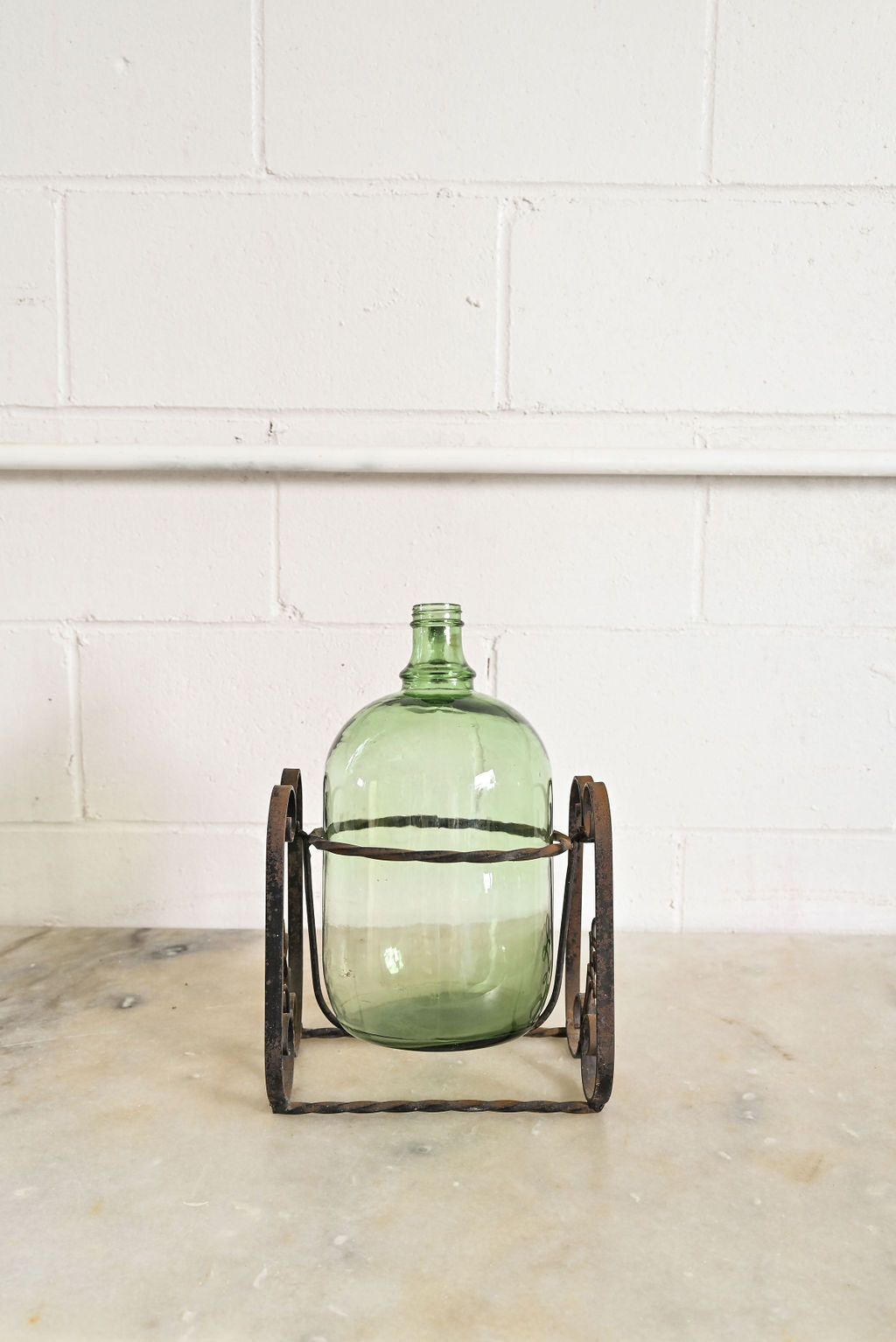 1970s french demijohn with wrought iron stand