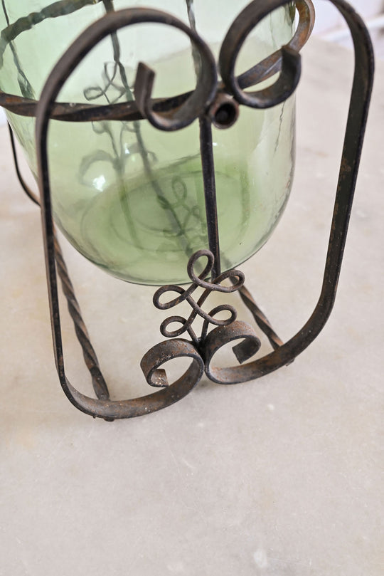 1970s french demijohn with wrought iron stand