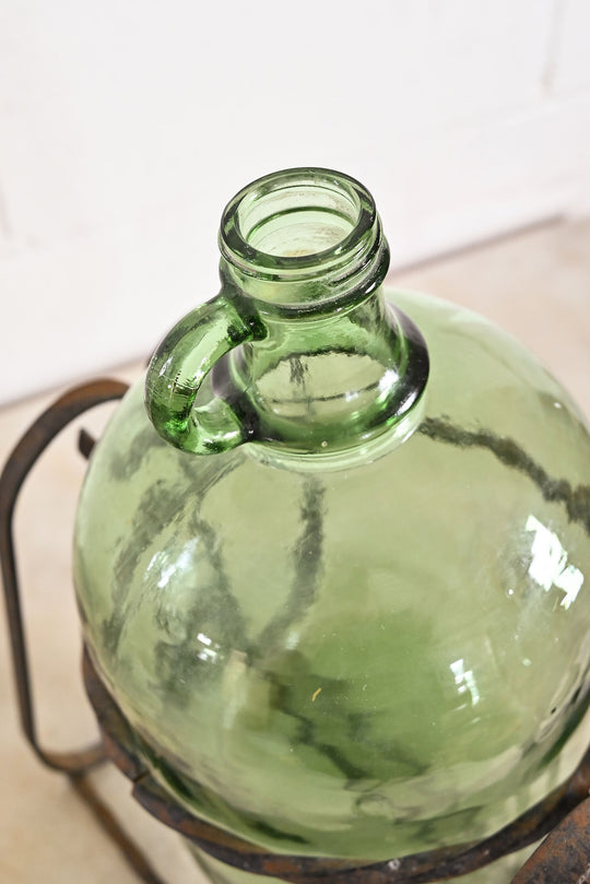 1970s french demijohn with wrought iron stand