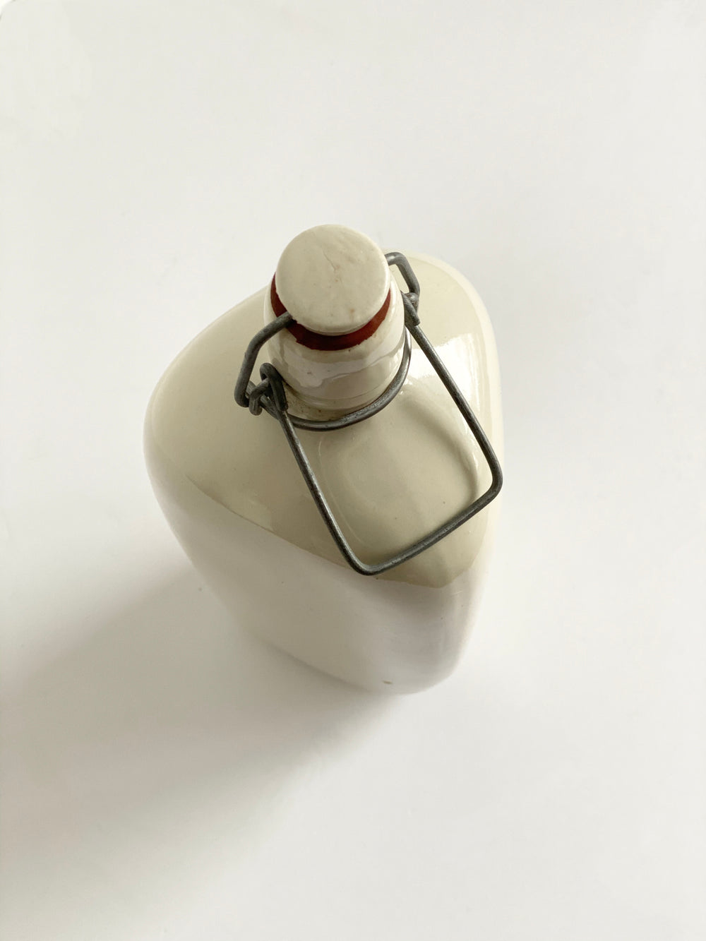 vintage French stoneware bottle, triangular with porcelain lid