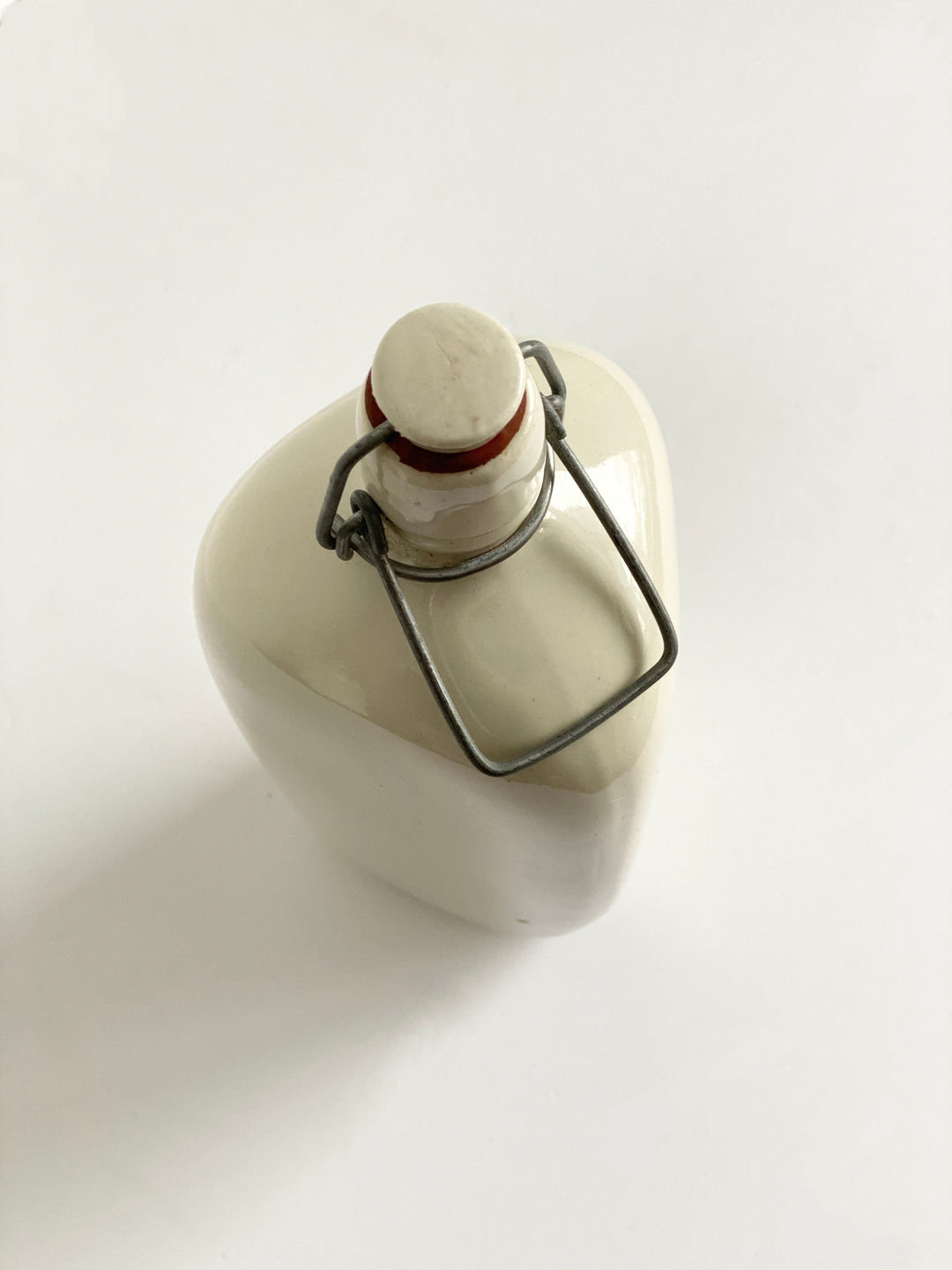 vintage French stoneware bottle, triangular with porcelain lid