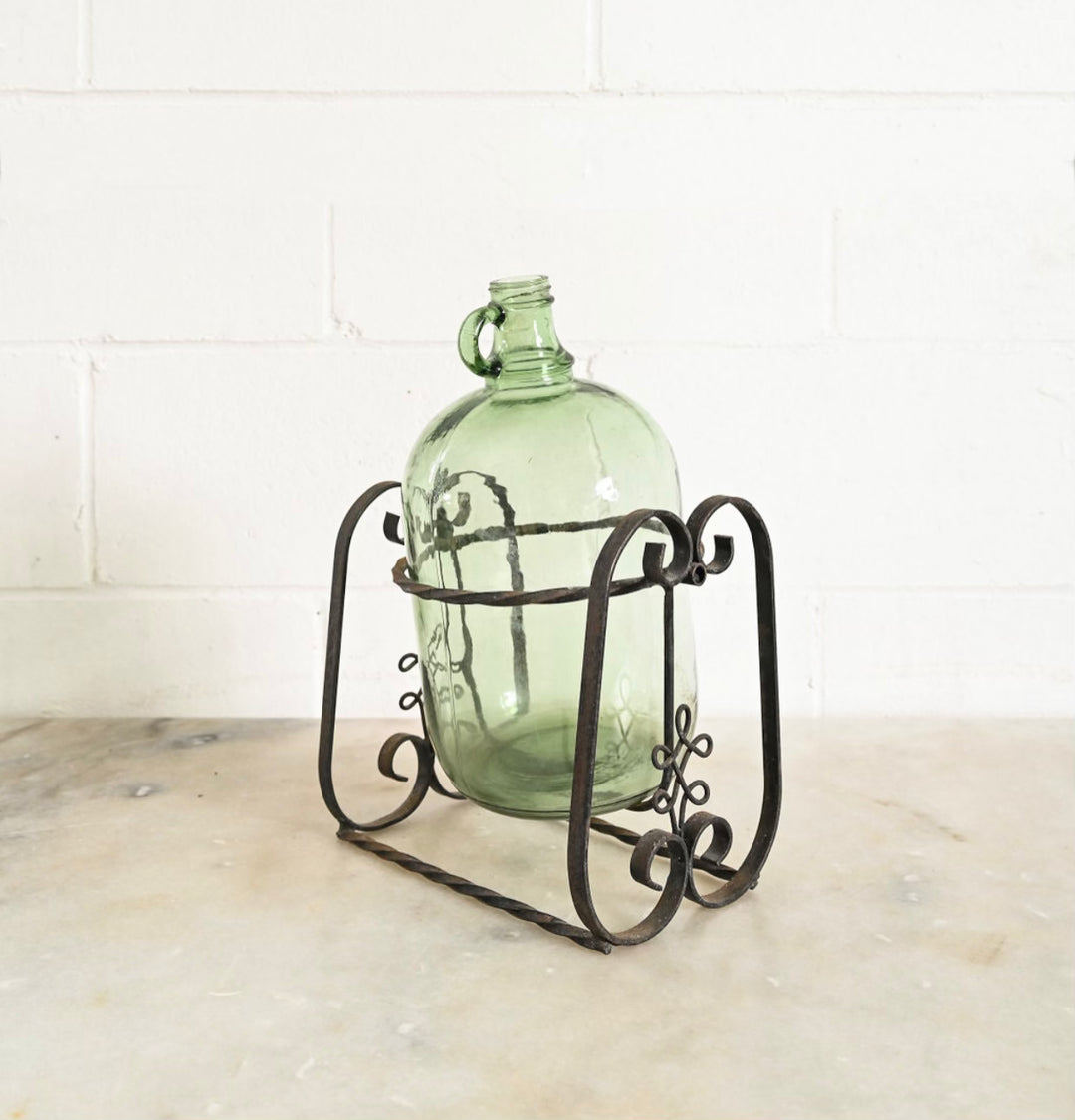 1970s french demijohn with wrought iron stand