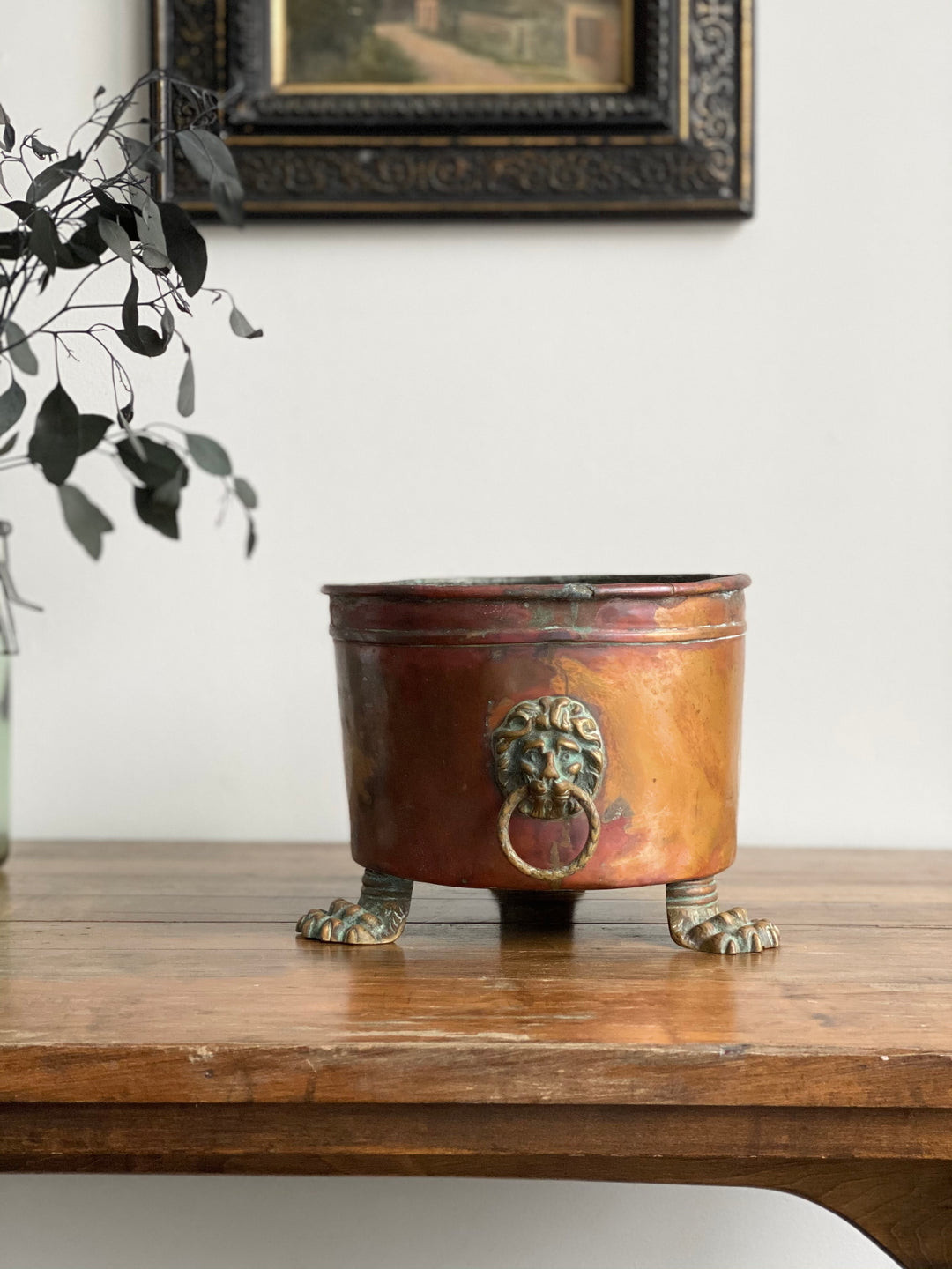 antique copper lion’s head footed planter