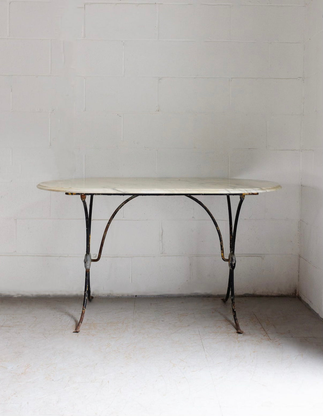 French bistro table with antique cast iron base and vintage marble top