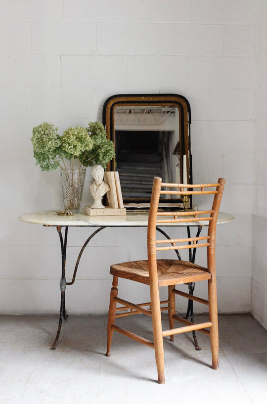 French bistro table with antique cast iron base and vintage marble top