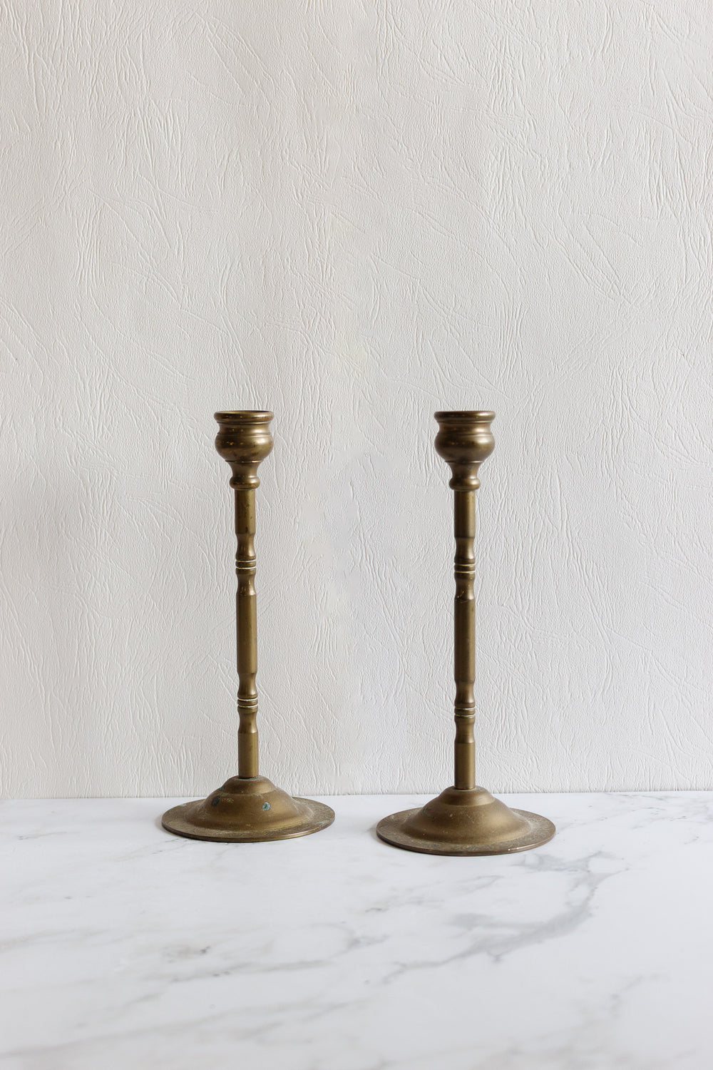 pair of antique french slender art deco brass candlesticks