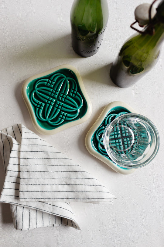pair of art deco bottle coasters