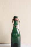 pair of vintage french green glass porcelain top bistro bottles