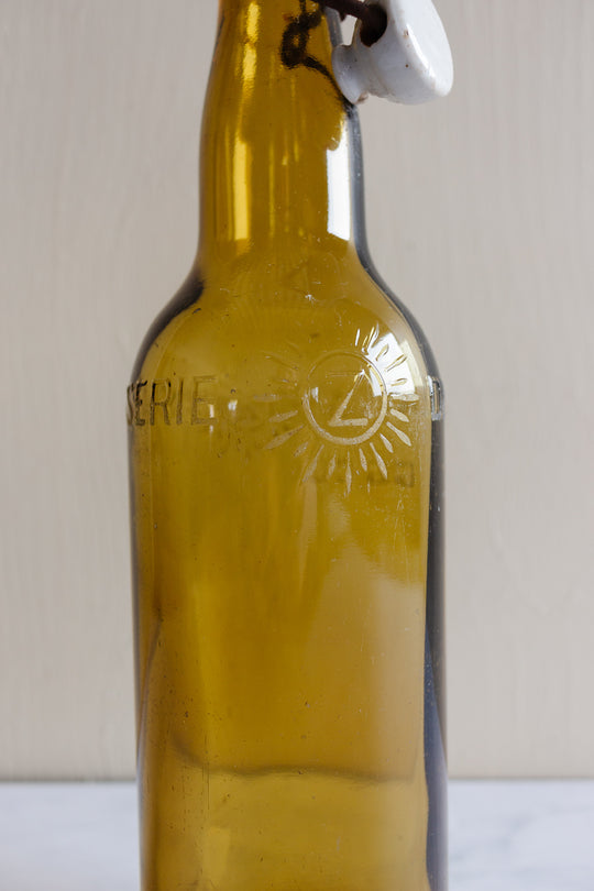 pair of vintage french amber brasserie bottles