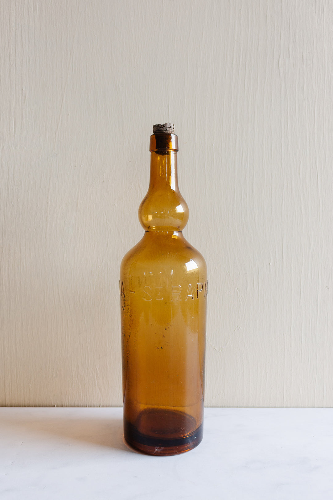 pair of vintage french amber brasserie bottles