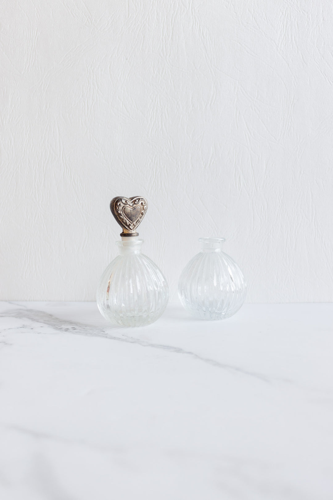 antique french perfume bottle pair with silver heart stopper