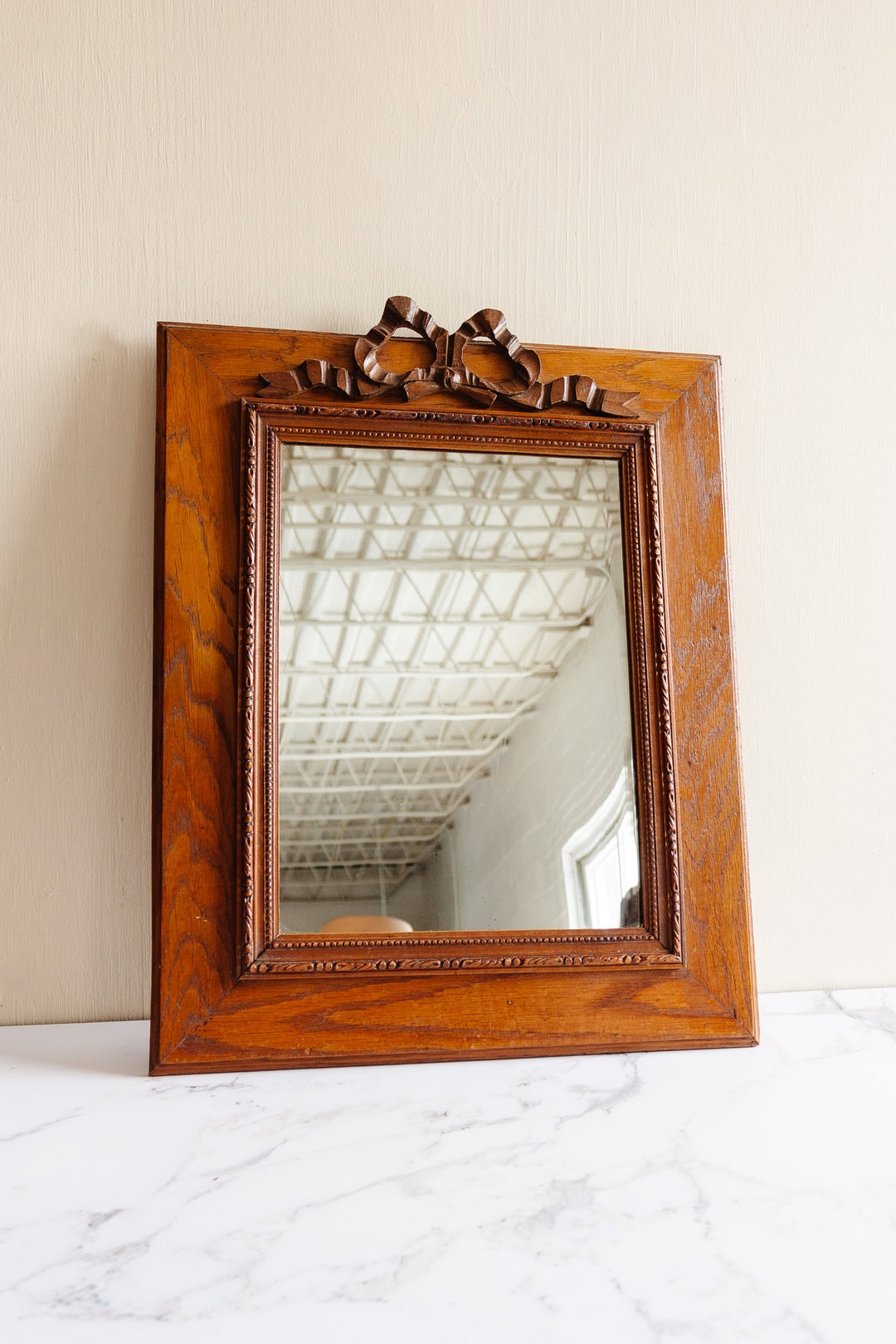 antique French carved oak mirror with Louis XVI style bow cornice