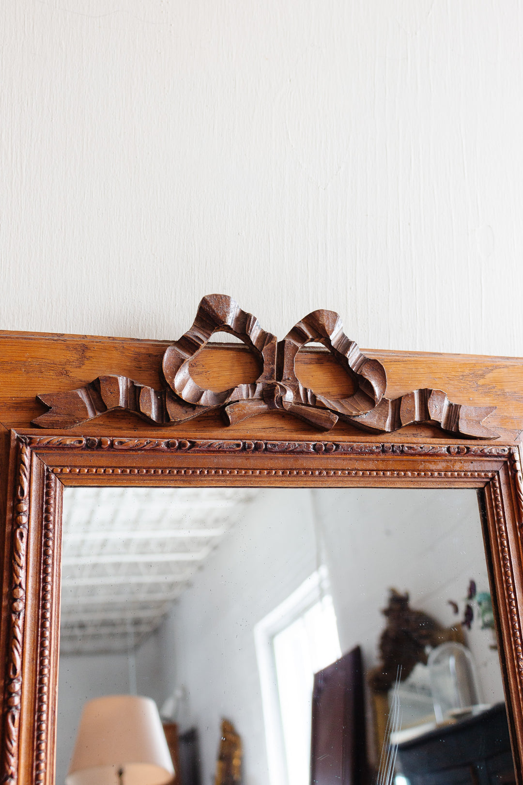 antique French carved oak mirror with Louis XVI style bow cornice