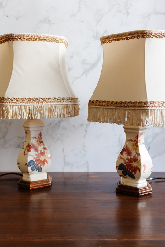 pair of vintage french handpainted porcelain lamps with fringed shades