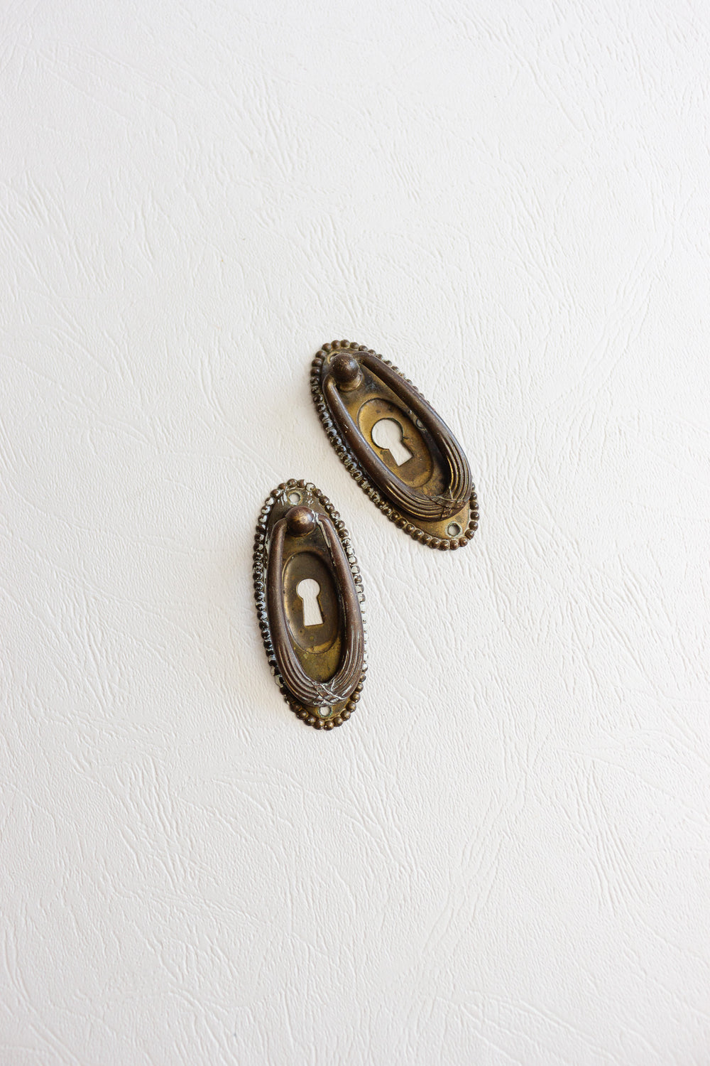 pair of antique french keyhole escutcheons