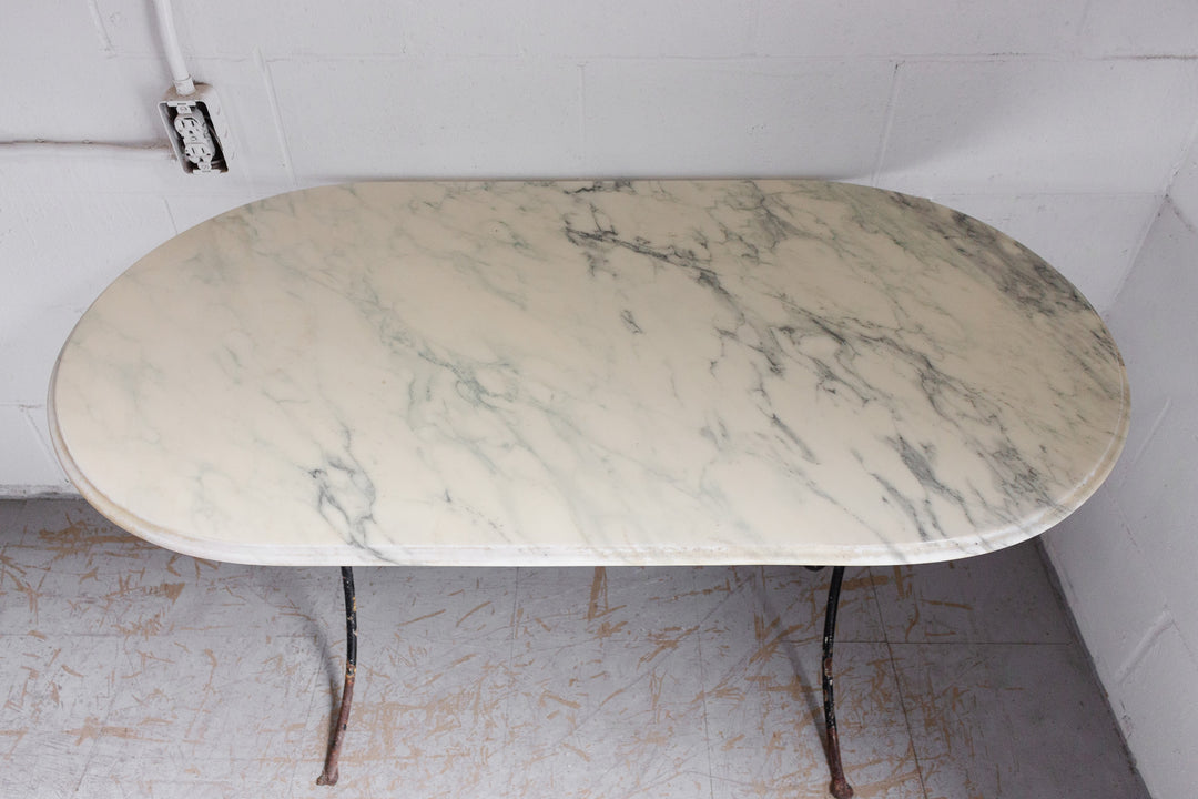 French bistro table with antique cast iron base and vintage marble top