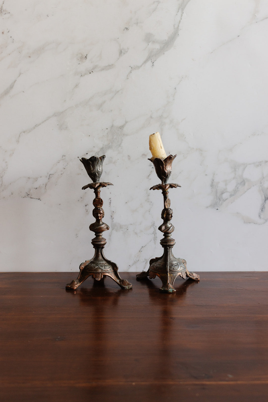 antique cast metal figural candlestick pair