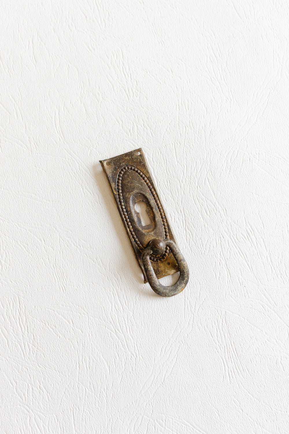 antique french gilt metal keyhole escutcheon with drop pull