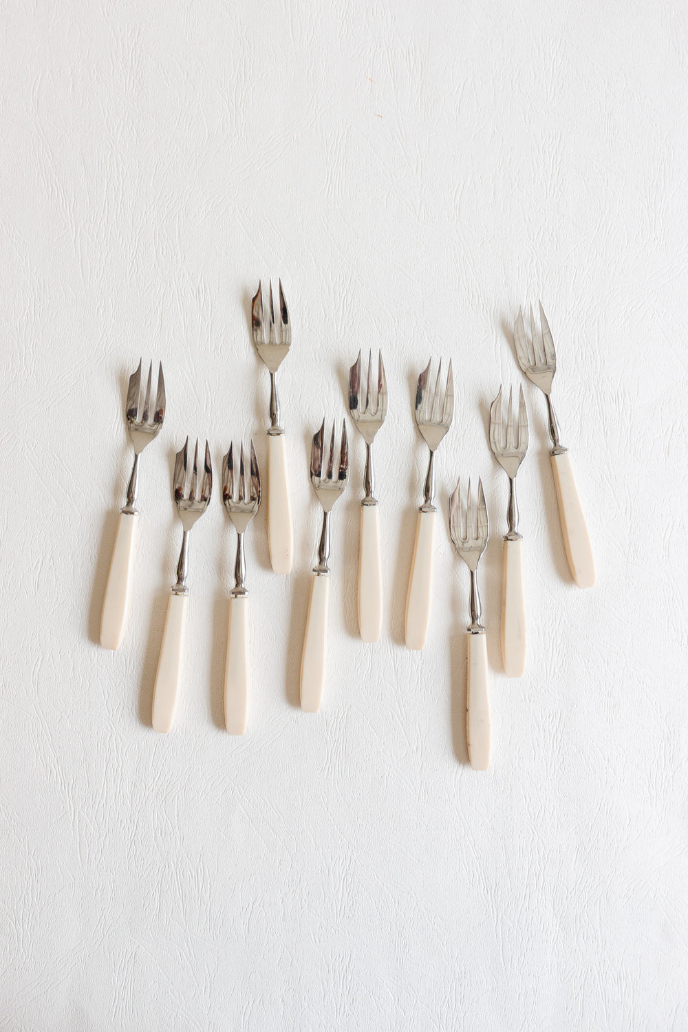 set of 10 vintage pastry forks with ivory-toned handles