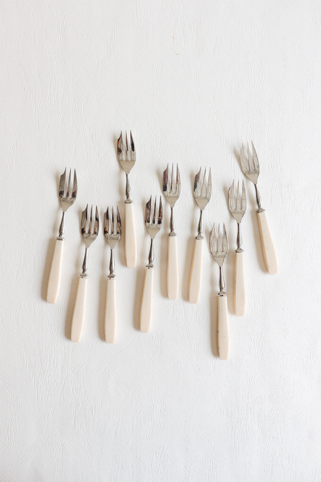set of 10 vintage pastry forks with ivory-toned handles