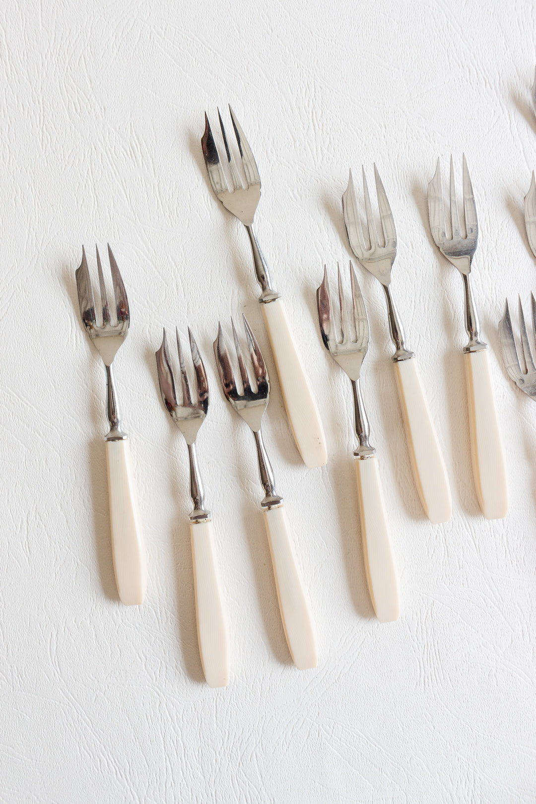 set of 10 vintage pastry forks with ivory-toned handles