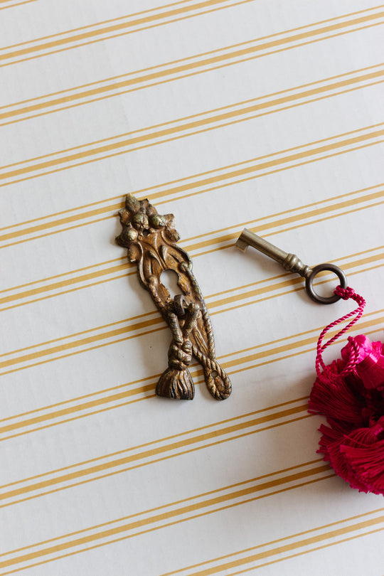 antique french gilt metal keyhole escutcheon with drop pull