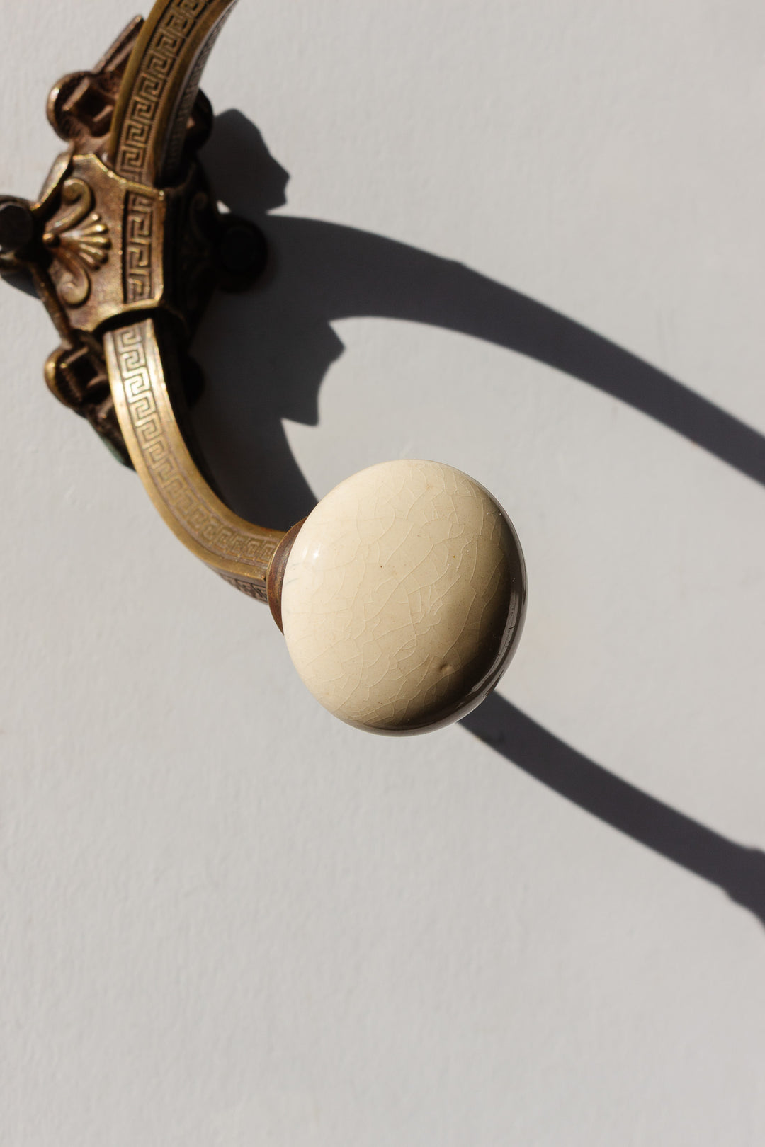 antique french embossed brass and porcelain wall hook