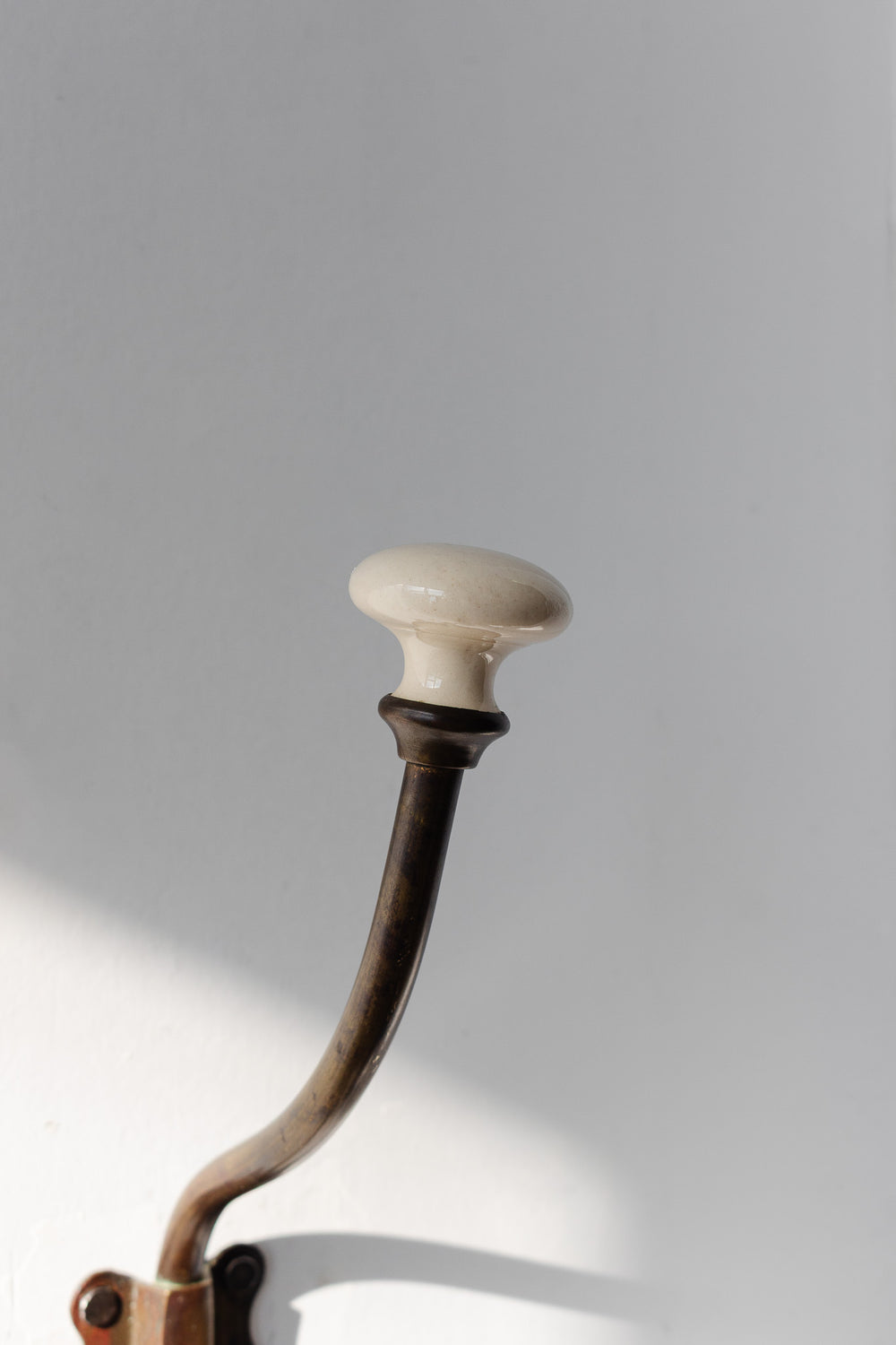 antique french cast iron and porcelain wall hook