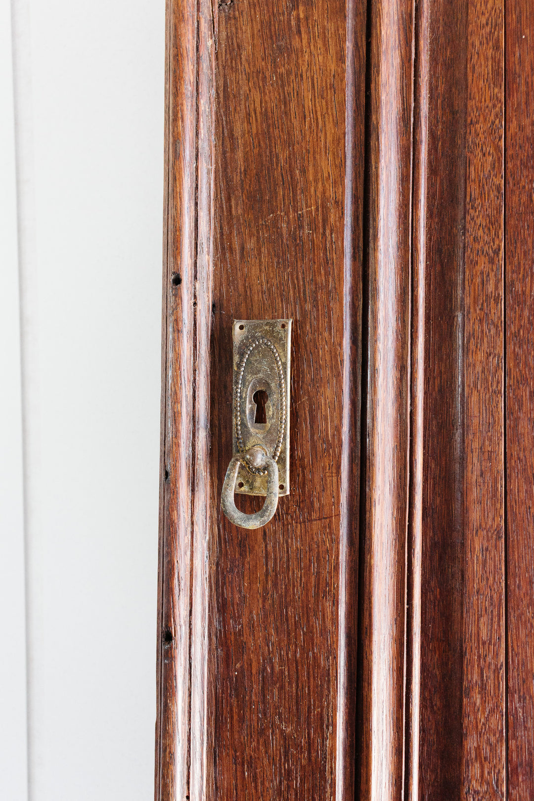 antique french gilt metal keyhole escutcheon with drop pull