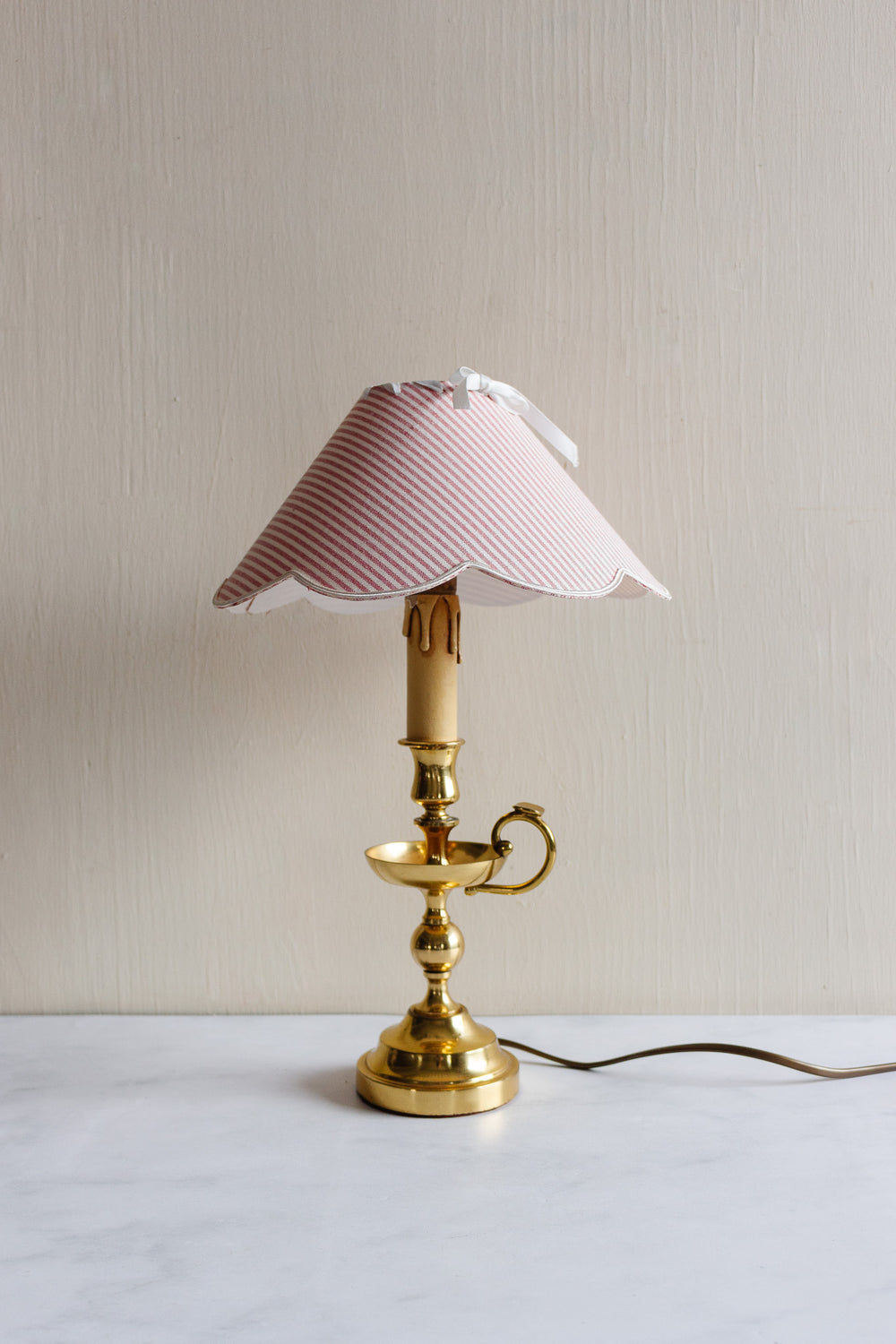 vintage French brass chamberstick lamp with scalloped ticking fabric shade