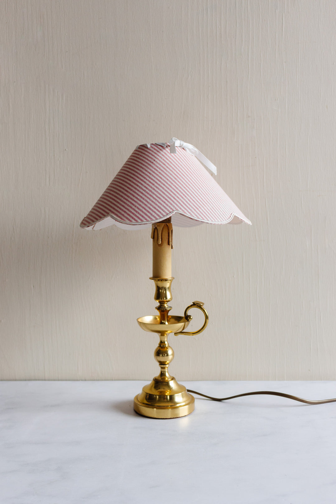 vintage French brass chamberstick lamp with scalloped ticking fabric shade