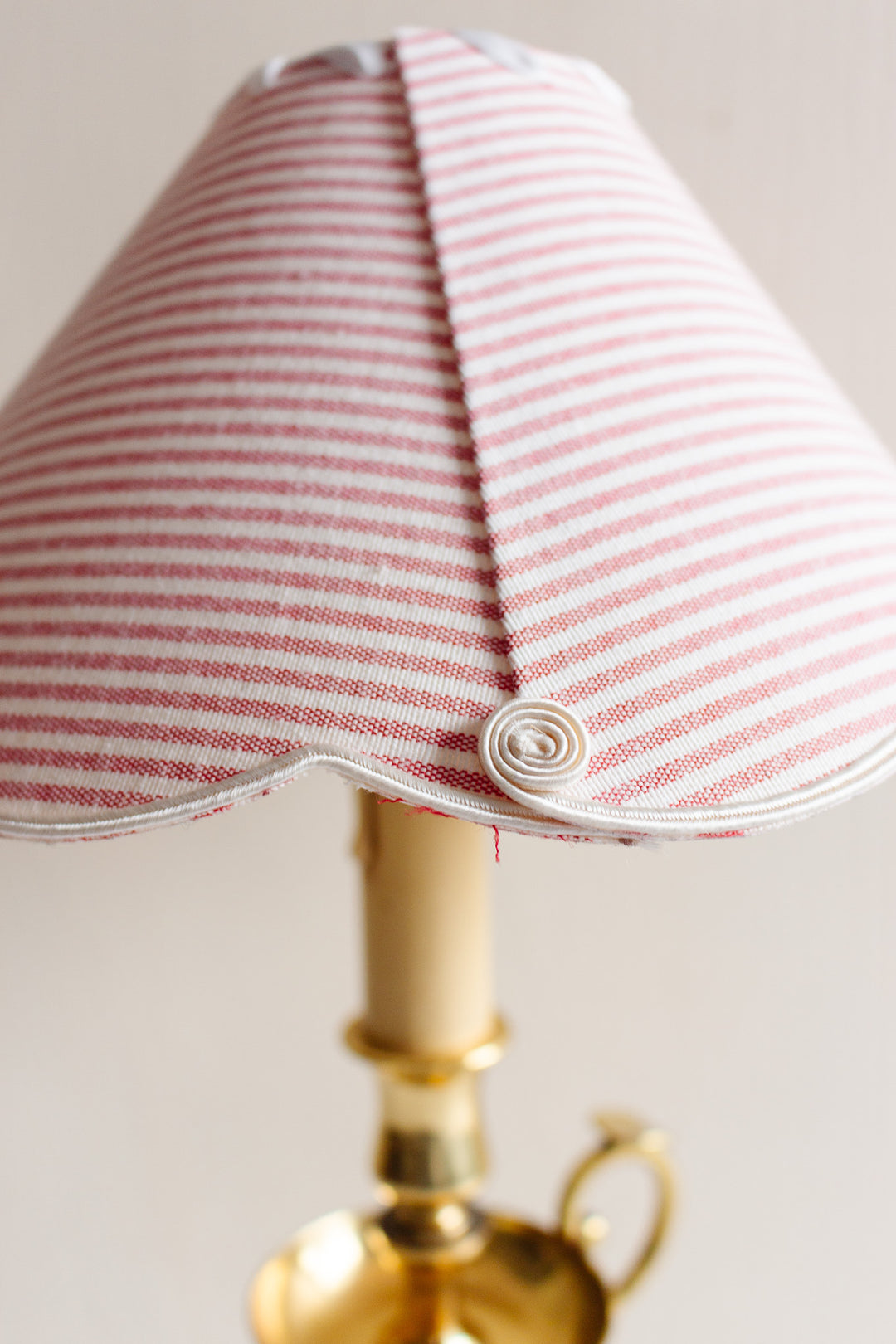 vintage French brass chamberstick lamp with scalloped ticking fabric shade