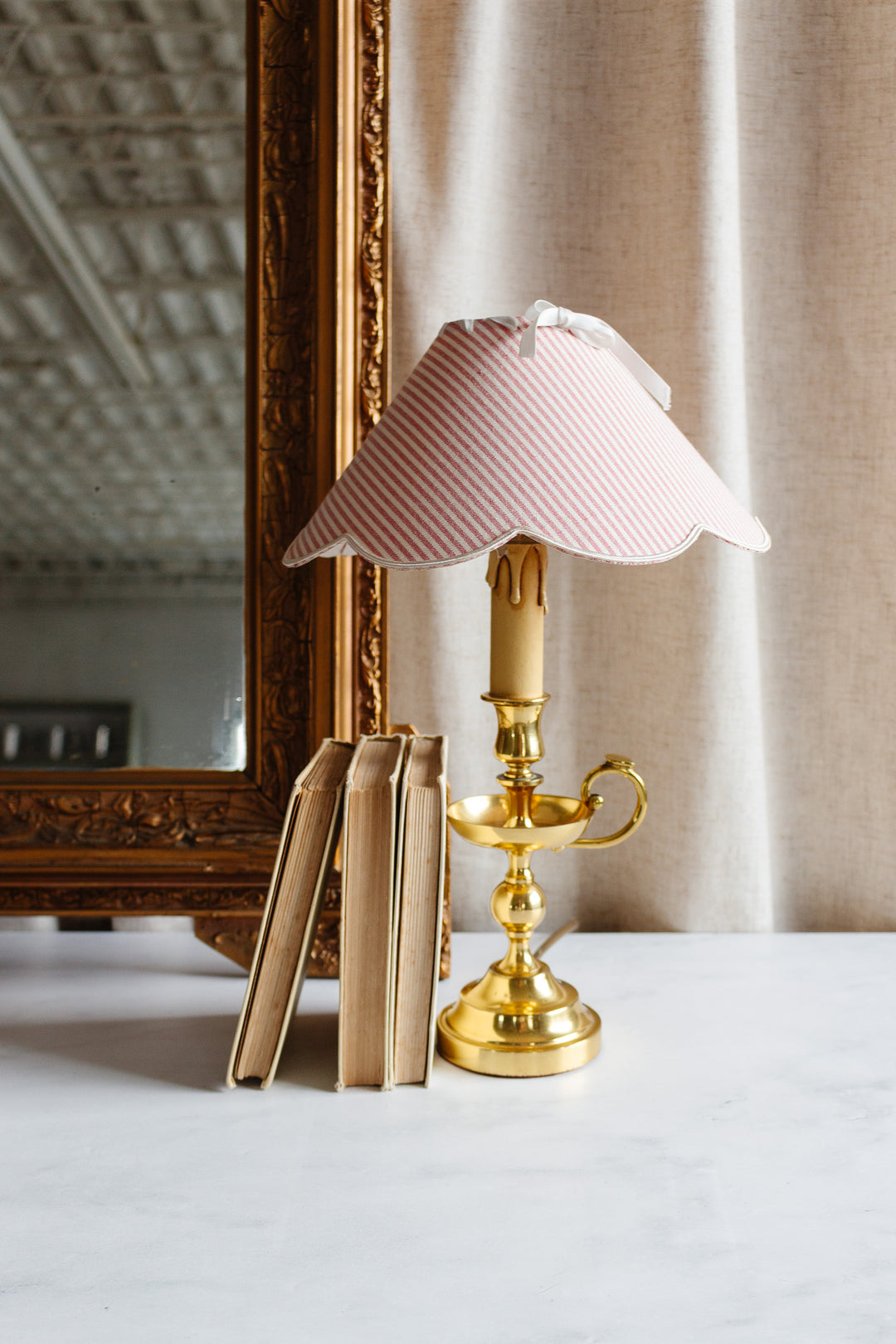 vintage French brass chamberstick lamp with scalloped ticking fabric shade