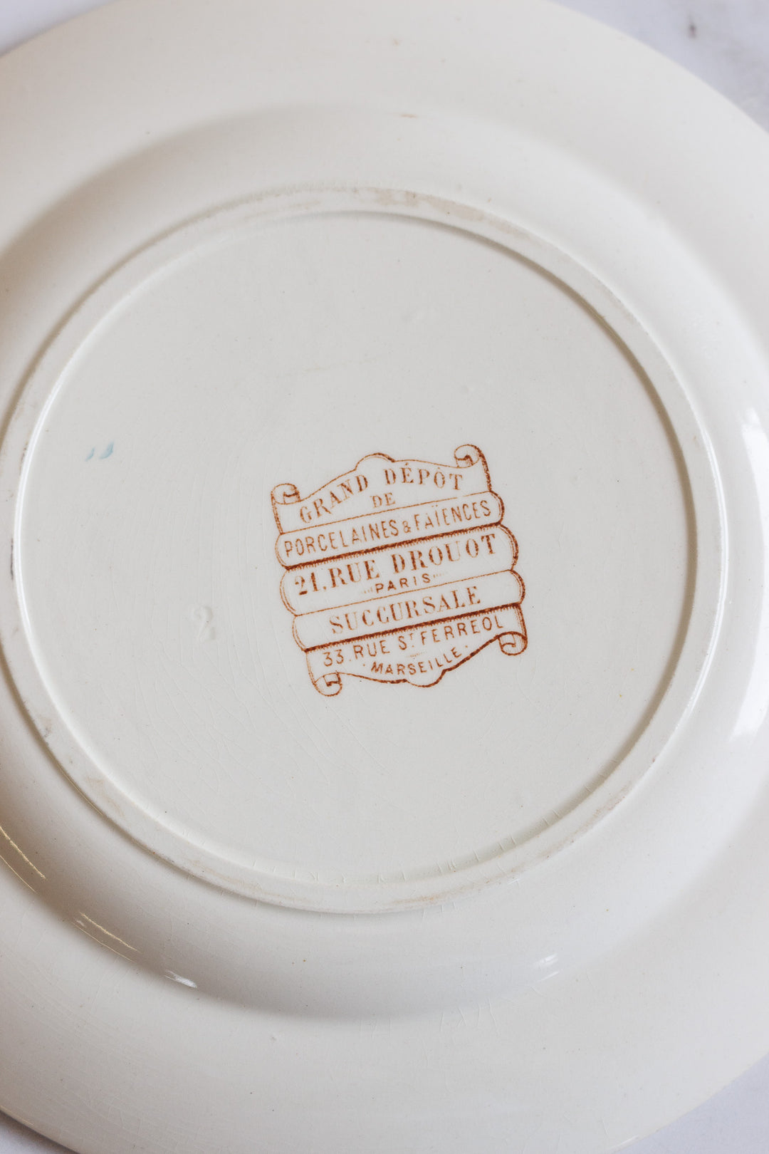 1880s french terre de fer polychrome plate commissioned by Grand Dépôt