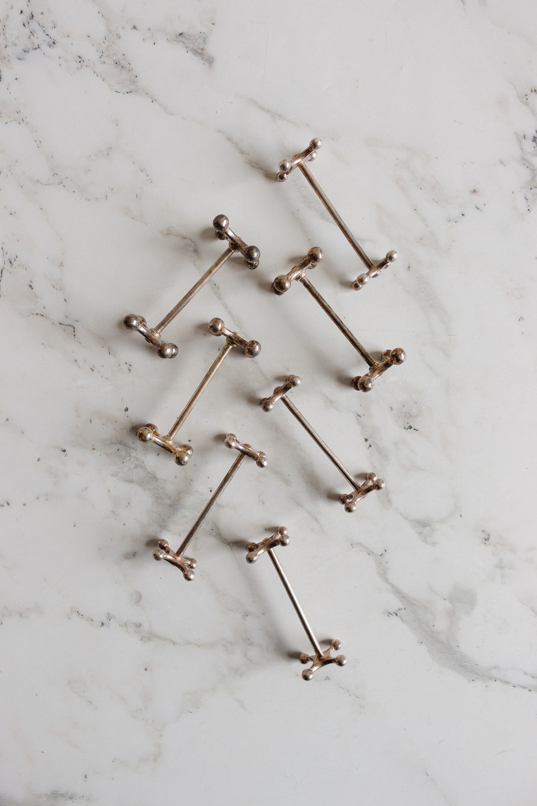 vintage french silverplated cogged knife rests, set of 7