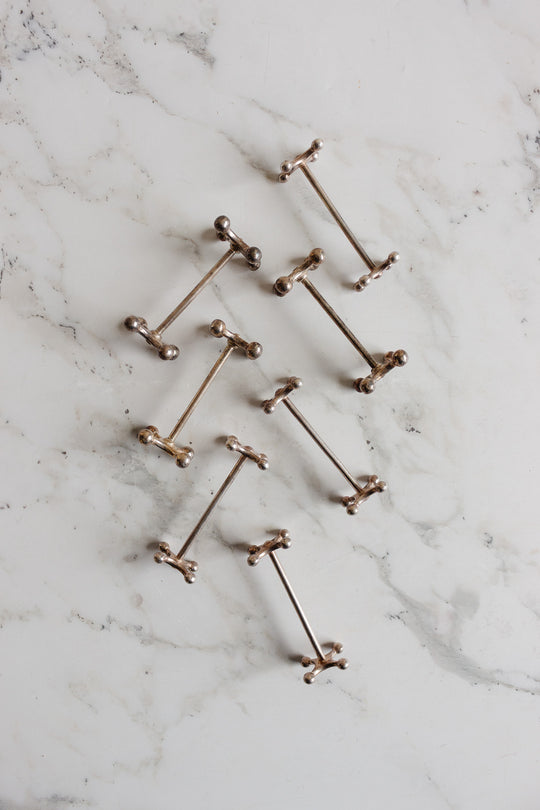 vintage french silverplated cogged knife rests, set of 7
