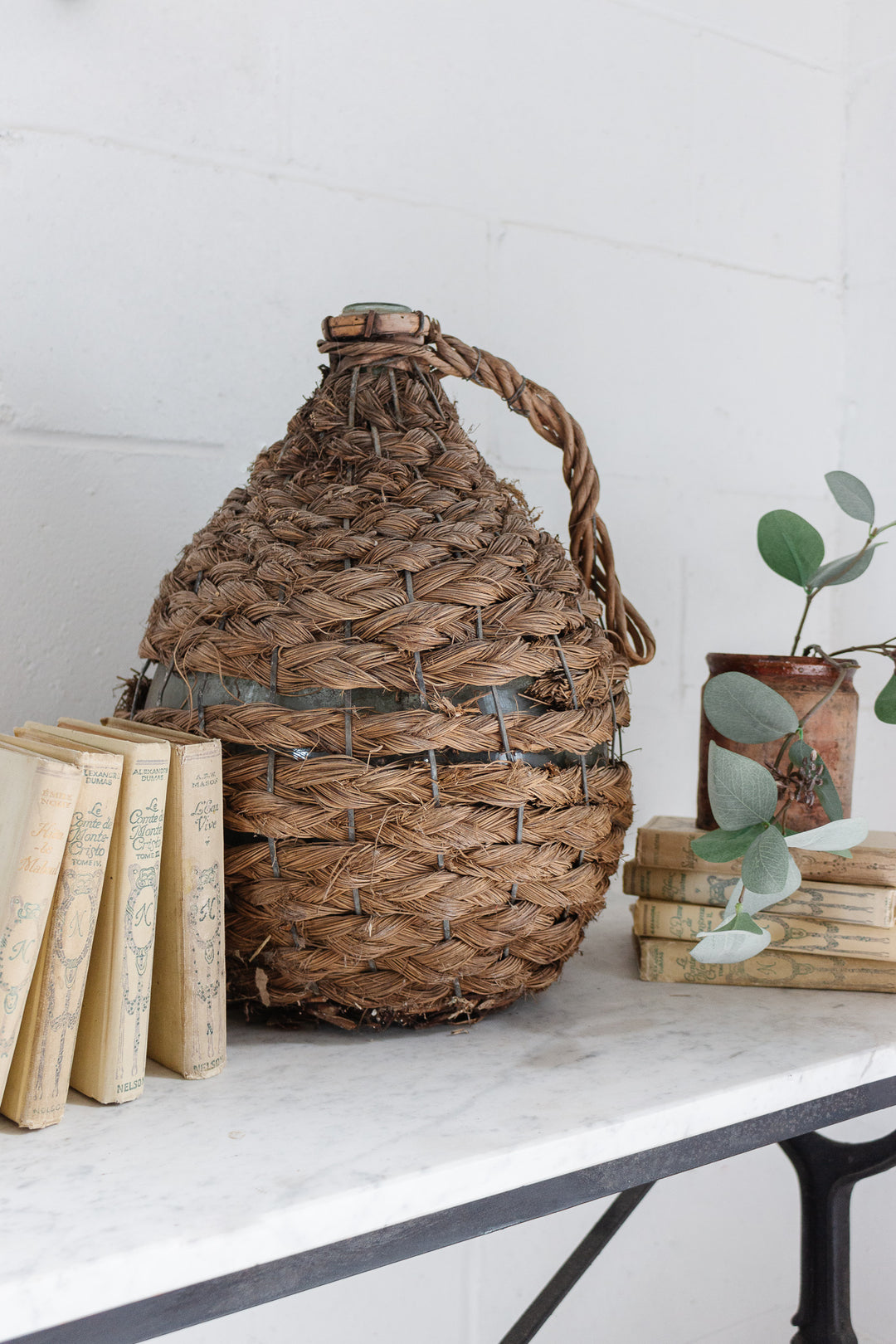 antique french wicker wrapped demijohn