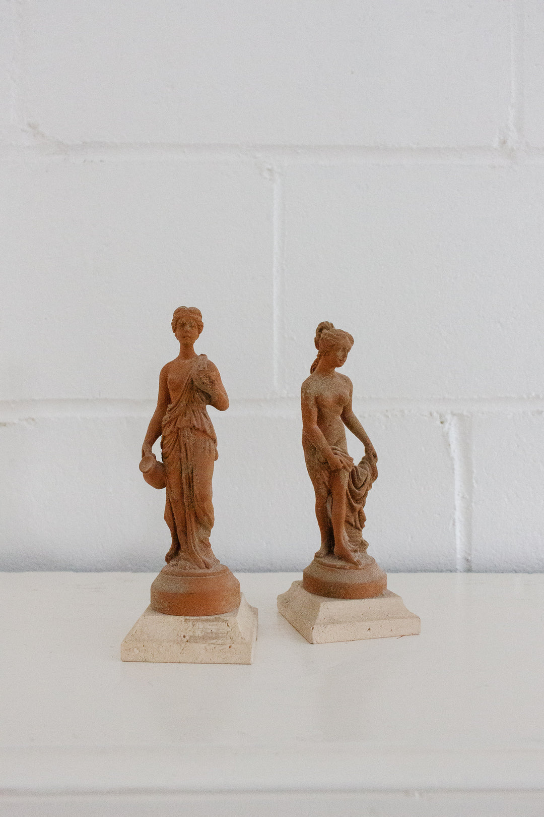 vintage Italian Grecian terra cotta sculptures with tivoli travertine base