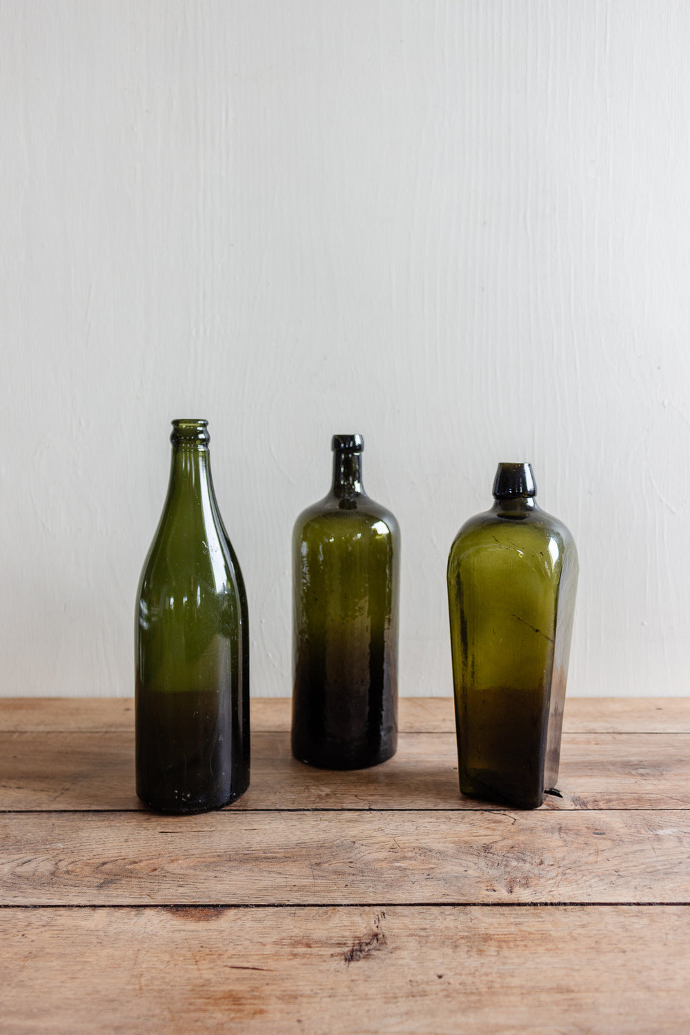 set of three antique green glass bottles