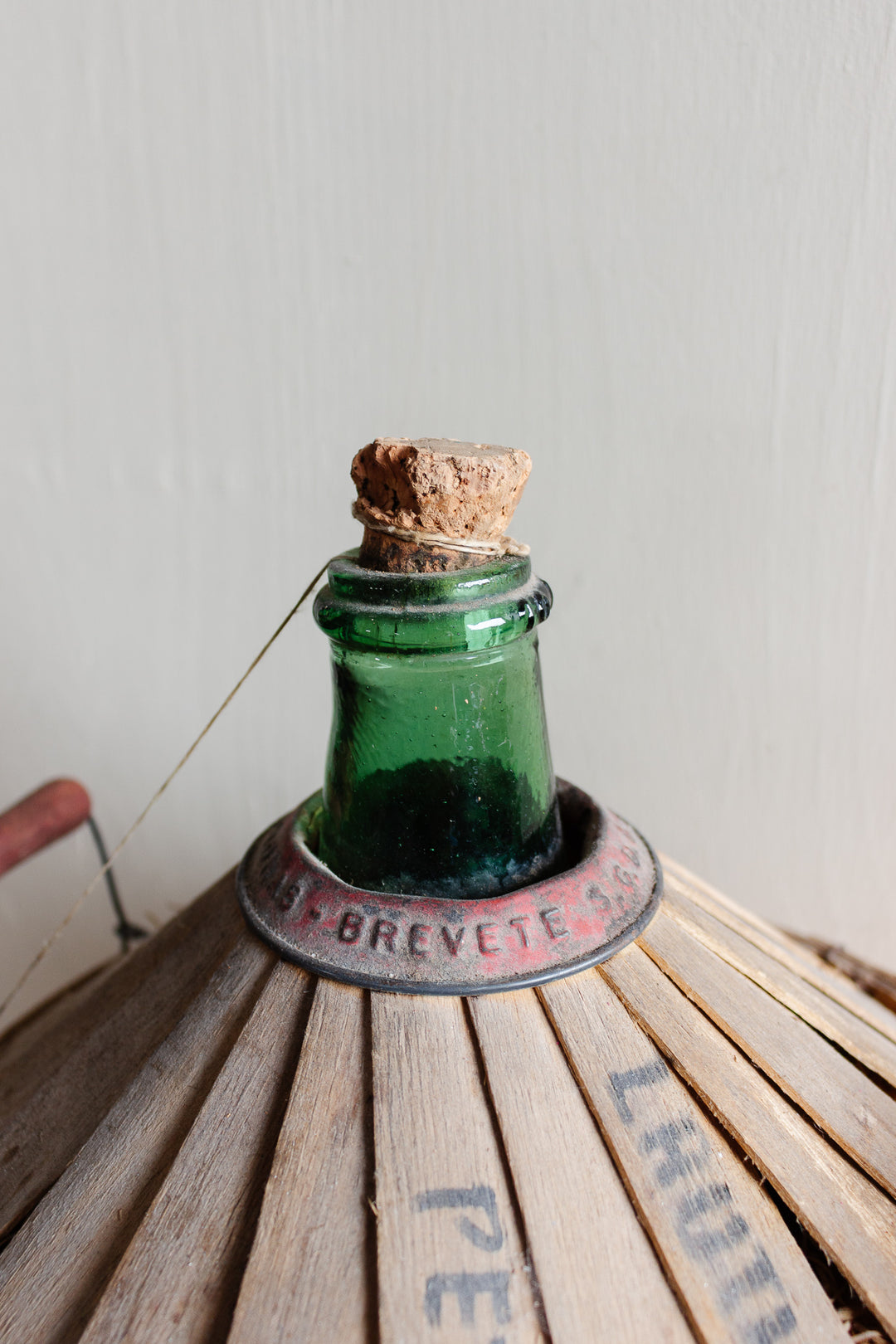 antique French Brevete Perrin & Fils Rognonas demijohn with wood strapping