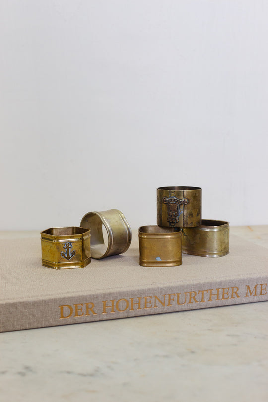 set of 5 assorted brass napkin rings
