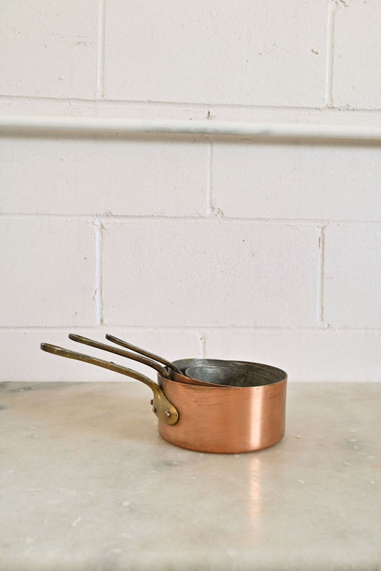 vintage French copper stamped sauciers, graduated set of 3