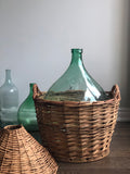 vintage demijohn in wicker basket