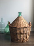 vintage demijohn in wicker basket